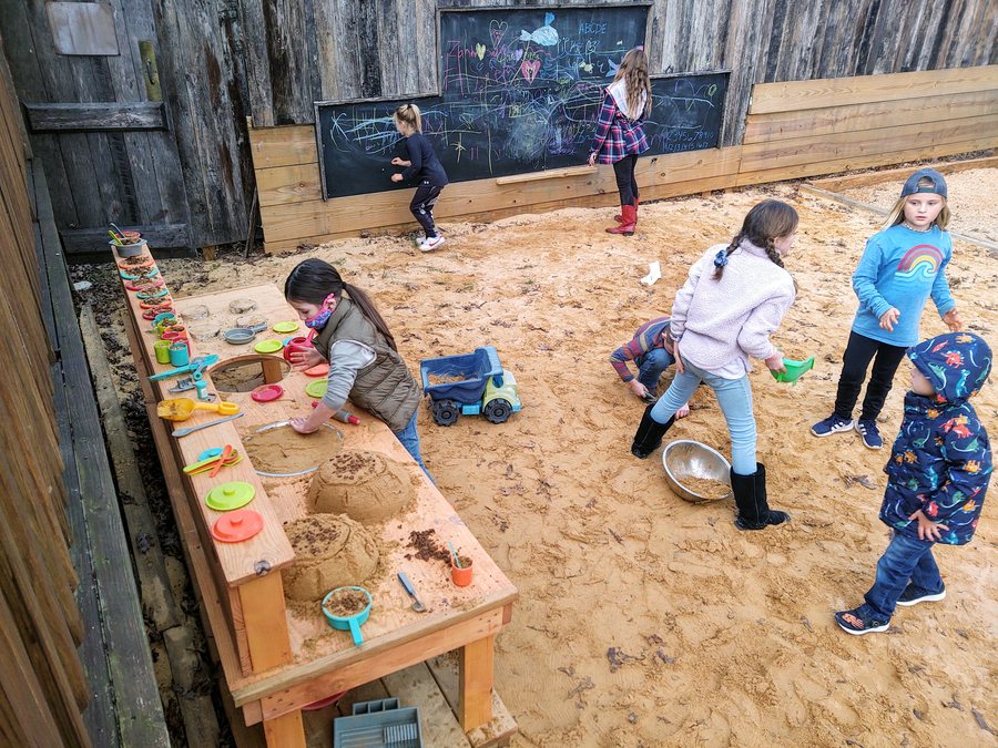 Kids playing in the sandbox at Brewing Tree